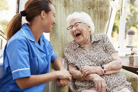 Care at home in Peterborough. Elderly care. Senior woman laughing with carer. domiciliary care.
